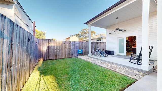 view of yard featuring a patio area and ceiling fan