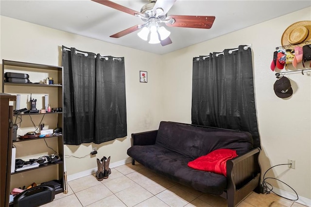 interior space with ceiling fan and light tile patterned flooring