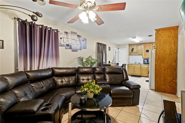 living room featuring ceiling fan and light tile patterned floors