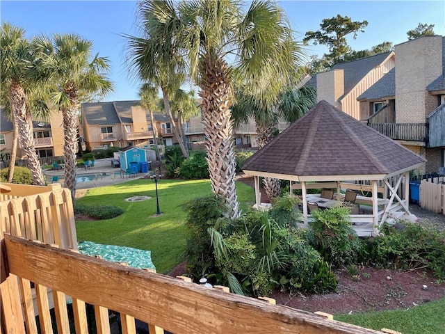 view of home's community featuring a patio area, a gazebo, and a lawn