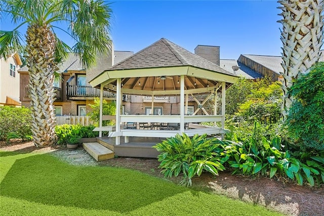 back of house with a gazebo and a yard