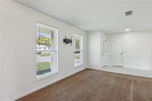 carpeted empty room with plenty of natural light