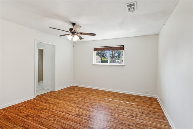 empty room featuring ceiling fan and hardwood / wood-style flooring