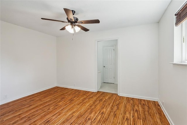 spare room with light hardwood / wood-style floors and ceiling fan