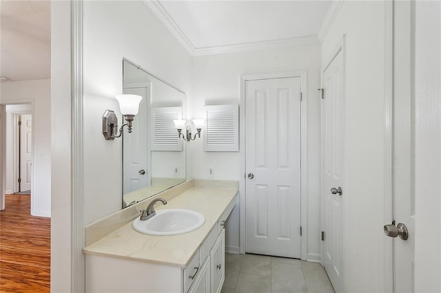 bathroom featuring crown molding, tile patterned flooring, and vanity