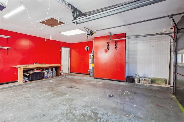 garage with a garage door opener and water heater