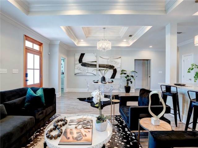 living room featuring a raised ceiling, hardwood / wood-style floors, and ornamental molding