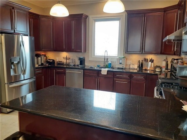 kitchen featuring light tile patterned flooring, sink, decorative light fixtures, backsplash, and appliances with stainless steel finishes