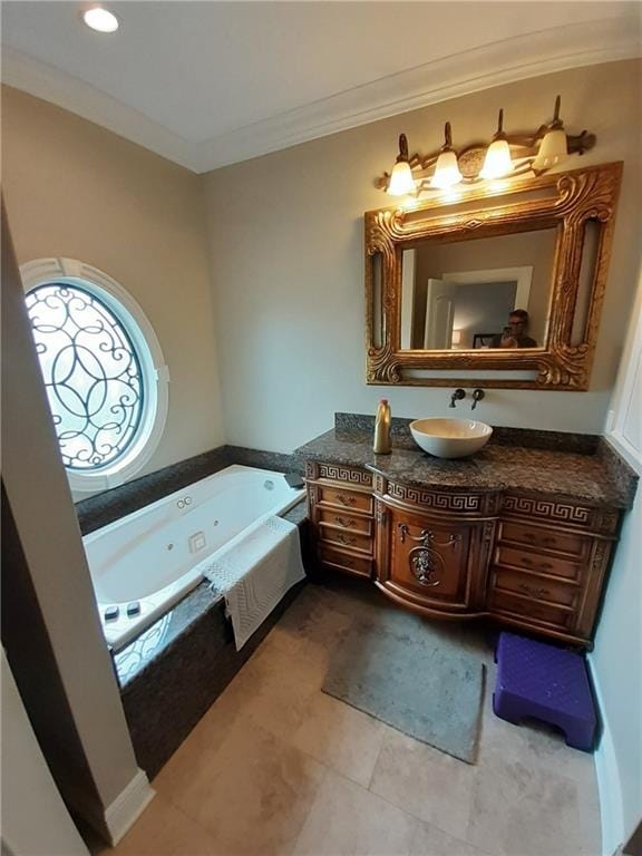 bathroom with tiled tub, vanity, tile patterned flooring, and ornamental molding