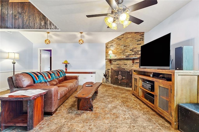 living room featuring lofted ceiling, a brick fireplace, and ceiling fan