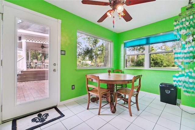 tiled dining space featuring ceiling fan