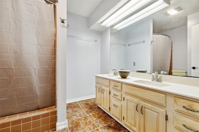 bathroom with toilet, a shower with curtain, vanity, and tile patterned flooring