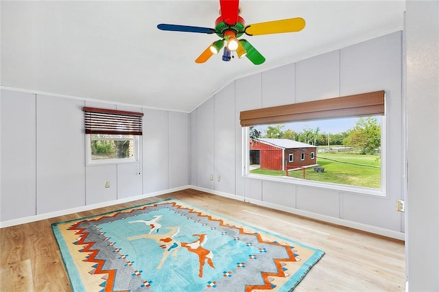 unfurnished living room featuring light hardwood / wood-style flooring, ceiling fan, and vaulted ceiling