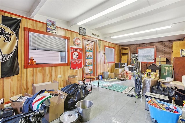 miscellaneous room featuring wood walls and beamed ceiling