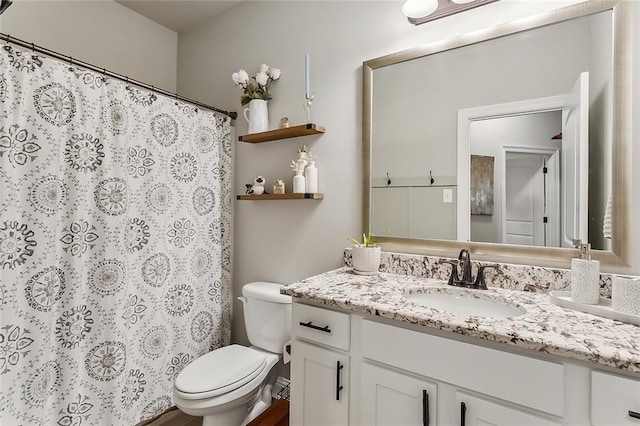 bathroom featuring vanity and toilet