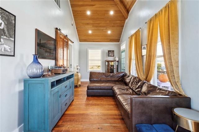 living room featuring light hardwood / wood-style floors, a barn door, wood ceiling, and a wealth of natural light