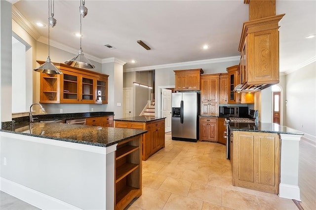 kitchen with pendant lighting, dark stone countertops, sink, stainless steel appliances, and kitchen peninsula