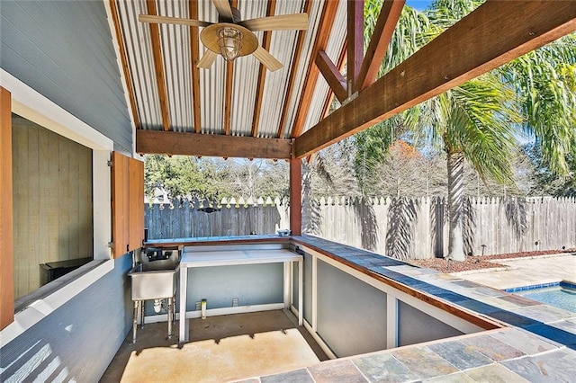 view of patio featuring ceiling fan and a fenced in pool