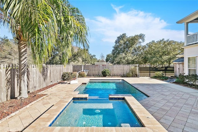 view of pool featuring an in ground hot tub and a patio