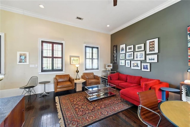 living room with hardwood / wood-style flooring and crown molding