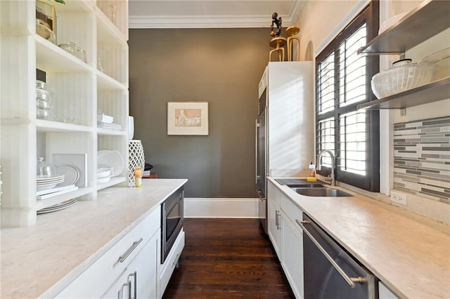 kitchen with sink, tasteful backsplash, white cabinetry, stainless steel appliances, and crown molding