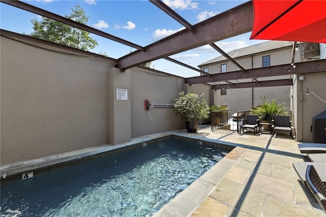 view of swimming pool with glass enclosure and a patio area