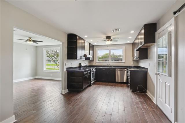 kitchen with stainless steel appliances, sink, plenty of natural light, and dark hardwood / wood-style floors