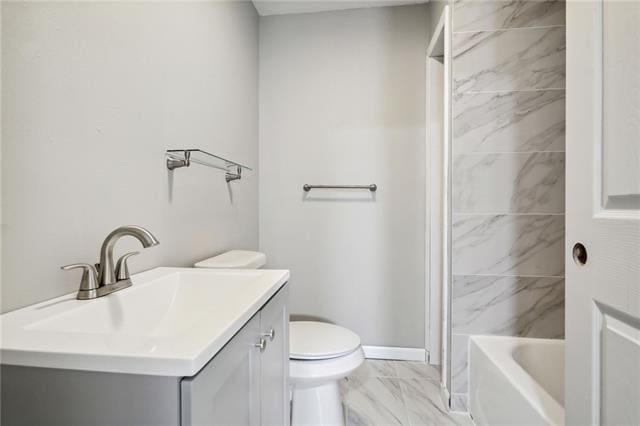 full bathroom featuring vanity, tiled shower / bath, and toilet