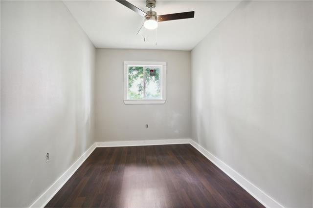 unfurnished room featuring ceiling fan and dark hardwood / wood-style flooring