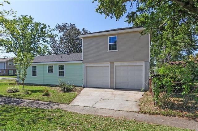 exterior space featuring a garage and a lawn