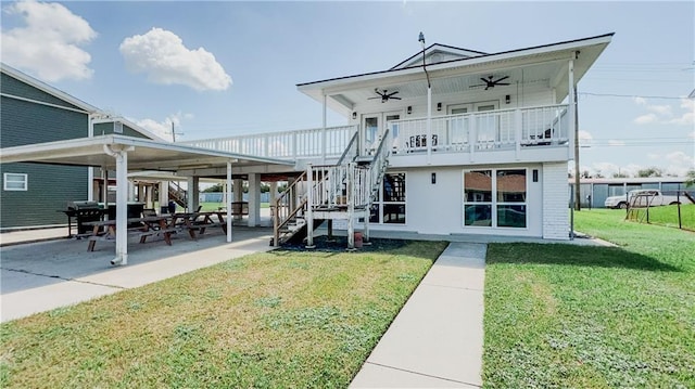 back of property featuring a yard, ceiling fan, and a patio area