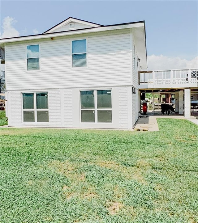 rear view of house with a yard and a deck