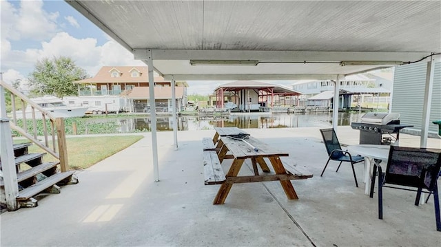 view of patio with a water view, a boat dock, and grilling area