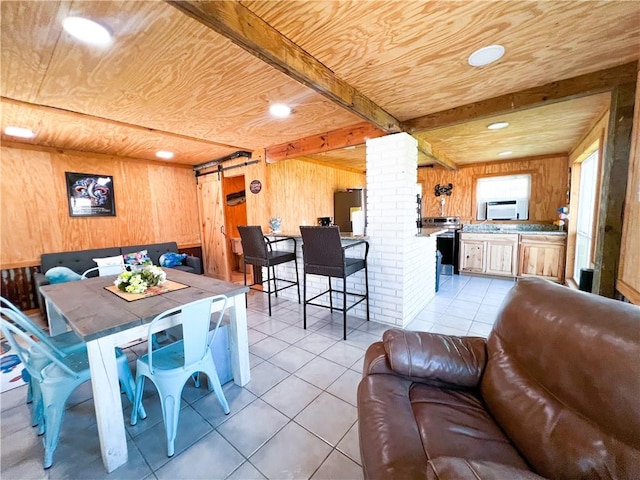 interior space with beamed ceiling, wooden walls, light tile patterned floors, and wood ceiling