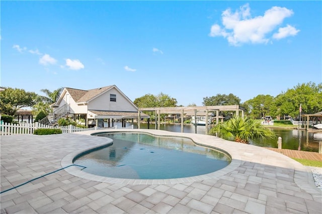 view of swimming pool with a patio area and a water view