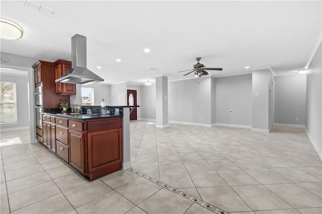 kitchen with crown molding, ceiling fan, light tile patterned floors, range hood, and stainless steel double oven