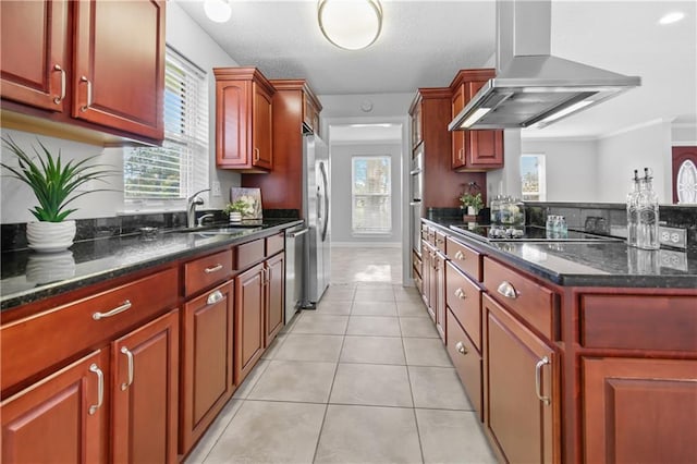 kitchen featuring dark stone counters, ventilation hood, sink, light tile patterned floors, and stainless steel appliances