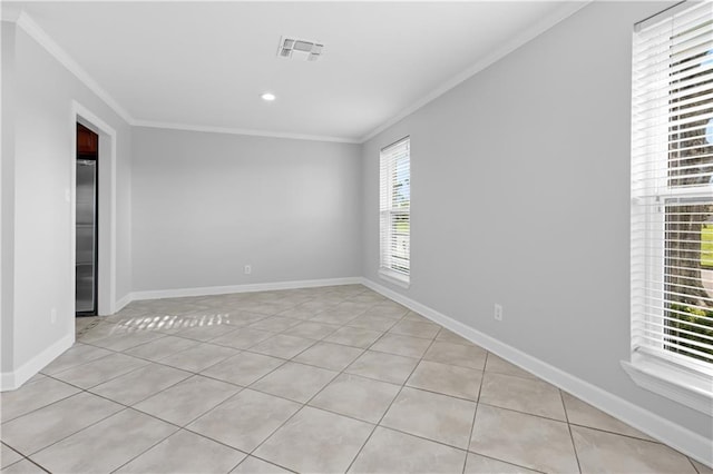 empty room featuring light tile patterned flooring and ornamental molding