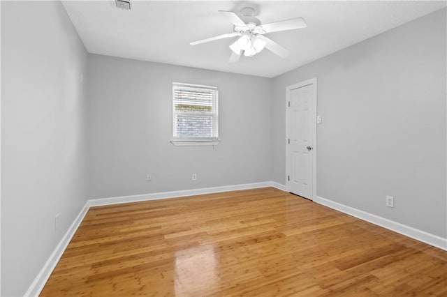 empty room with ceiling fan and hardwood / wood-style floors