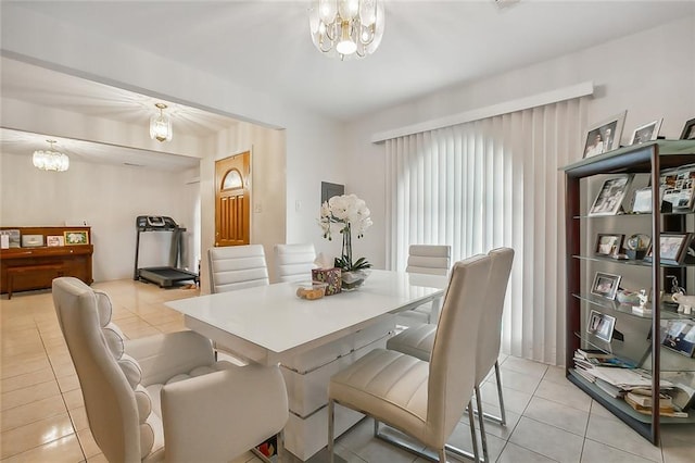 dining room with an inviting chandelier and light tile patterned flooring