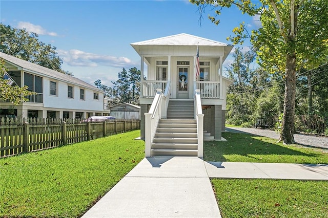 view of front of property with a porch and a front lawn