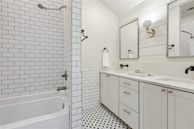 bathroom featuring vanity and tiled shower / bath combo