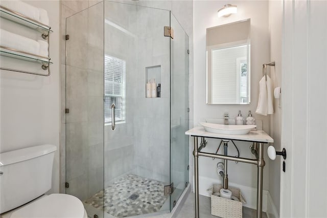 bathroom featuring walk in shower, vanity, and toilet