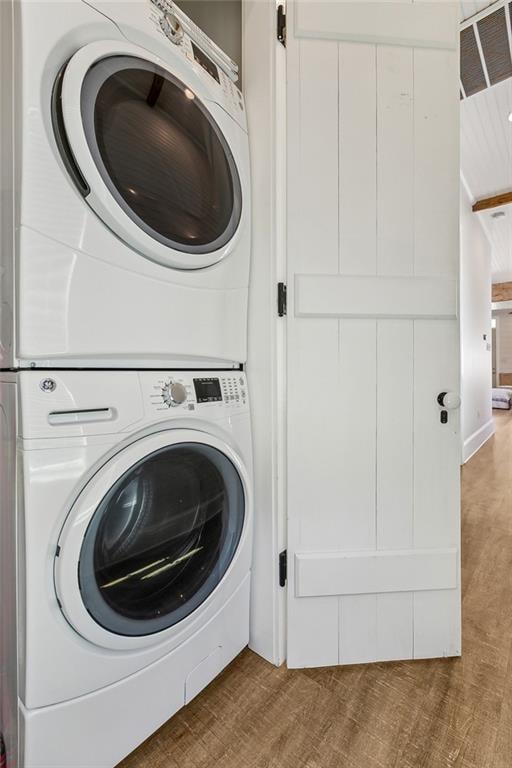 laundry area featuring stacked washer and clothes dryer