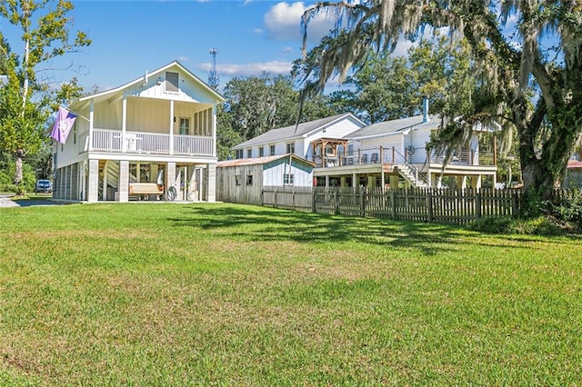 rear view of property featuring a lawn