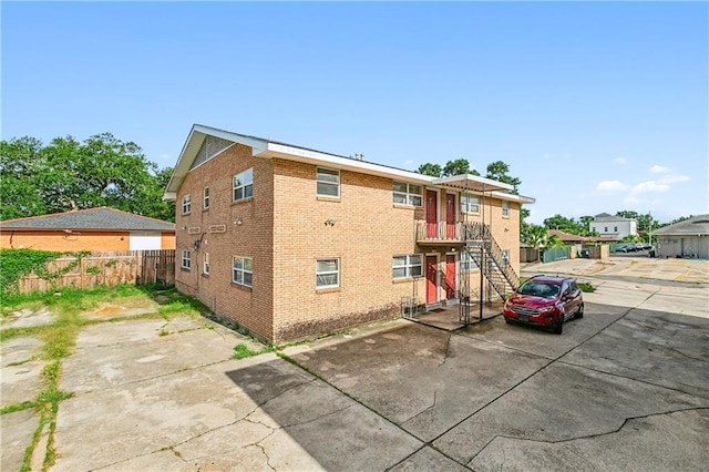 exterior space featuring stairs and fence