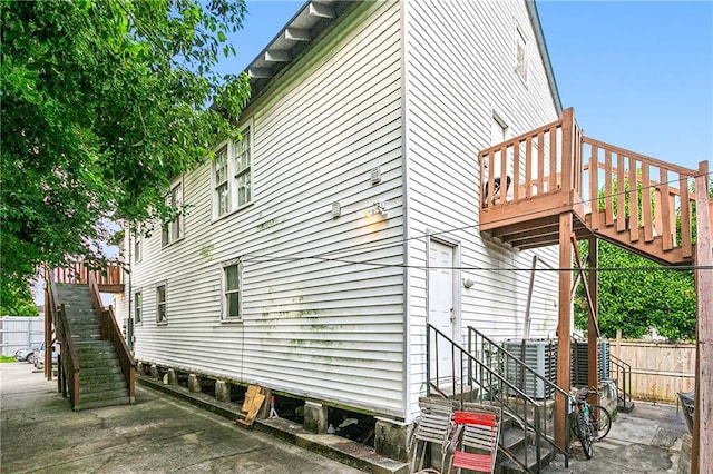 view of side of property with a wooden deck