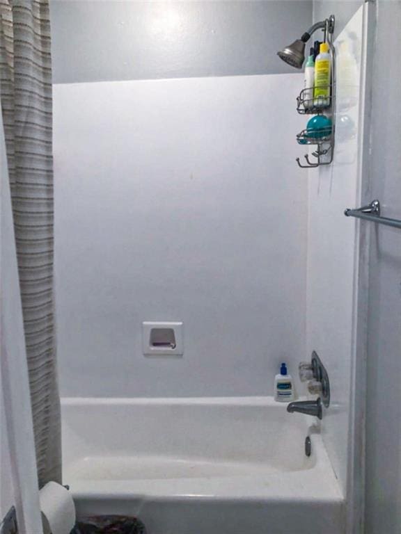 bathroom with shower / bathtub combination with curtain