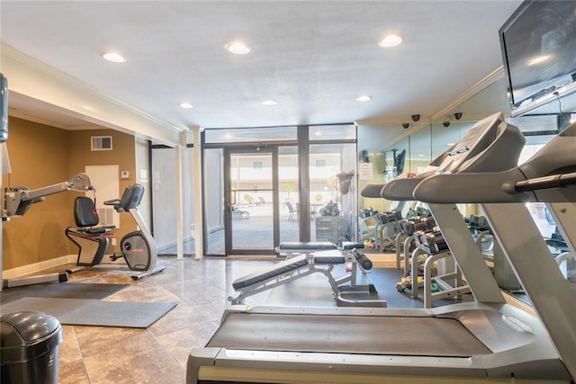 gym featuring expansive windows and crown molding