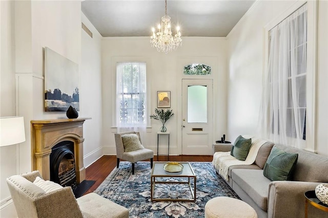 sitting room featuring dark wood-type flooring and a notable chandelier